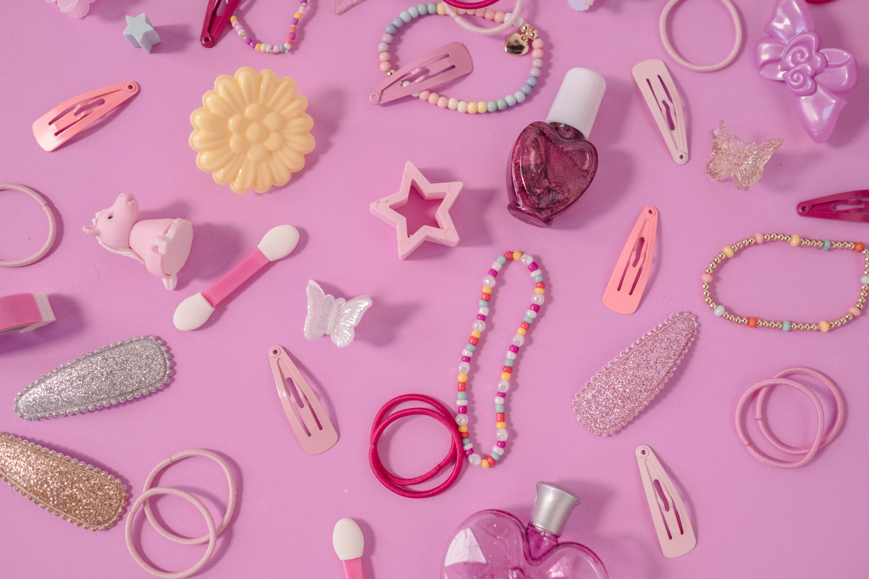 Assorted Hair Accessories and Trinkets on Pink Background
